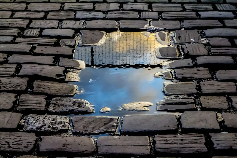 Puddle on a brick road