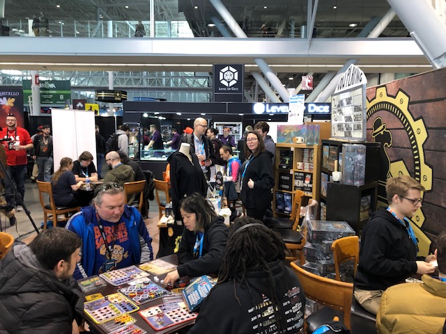 Con-goers playing board games