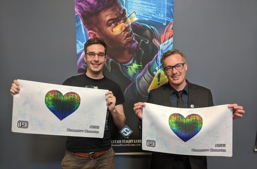 Johno and Spags with their Community Champion playmats